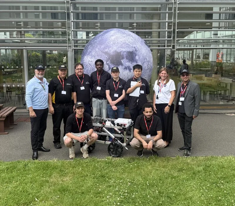 Newcastle Lunabotics team with their rover in front of the inflatable Moon