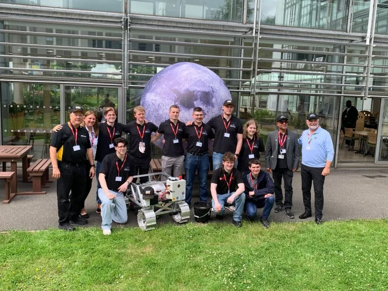 The QPL team and their rover in front of an inflatable Moon at The Open University